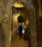 person-exploring-the-catacombs-in-rome-italy
