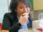 woman smiling at the camera whilst eating panettone