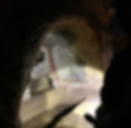 person-viewing-the-artwork-inside-a-catacomb-in-rome-italy